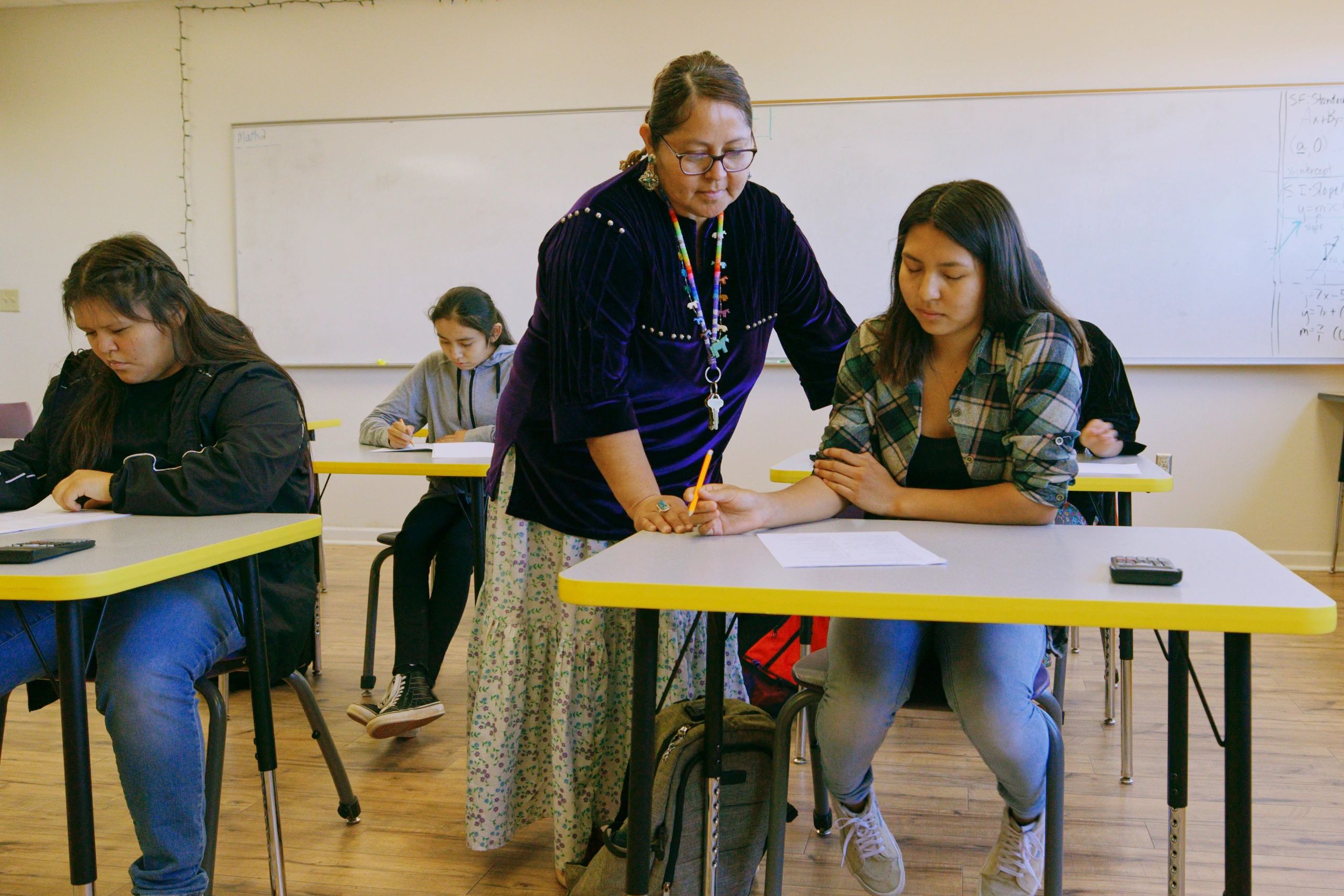 Teacher and students in a classroom at Royal Kings Schools