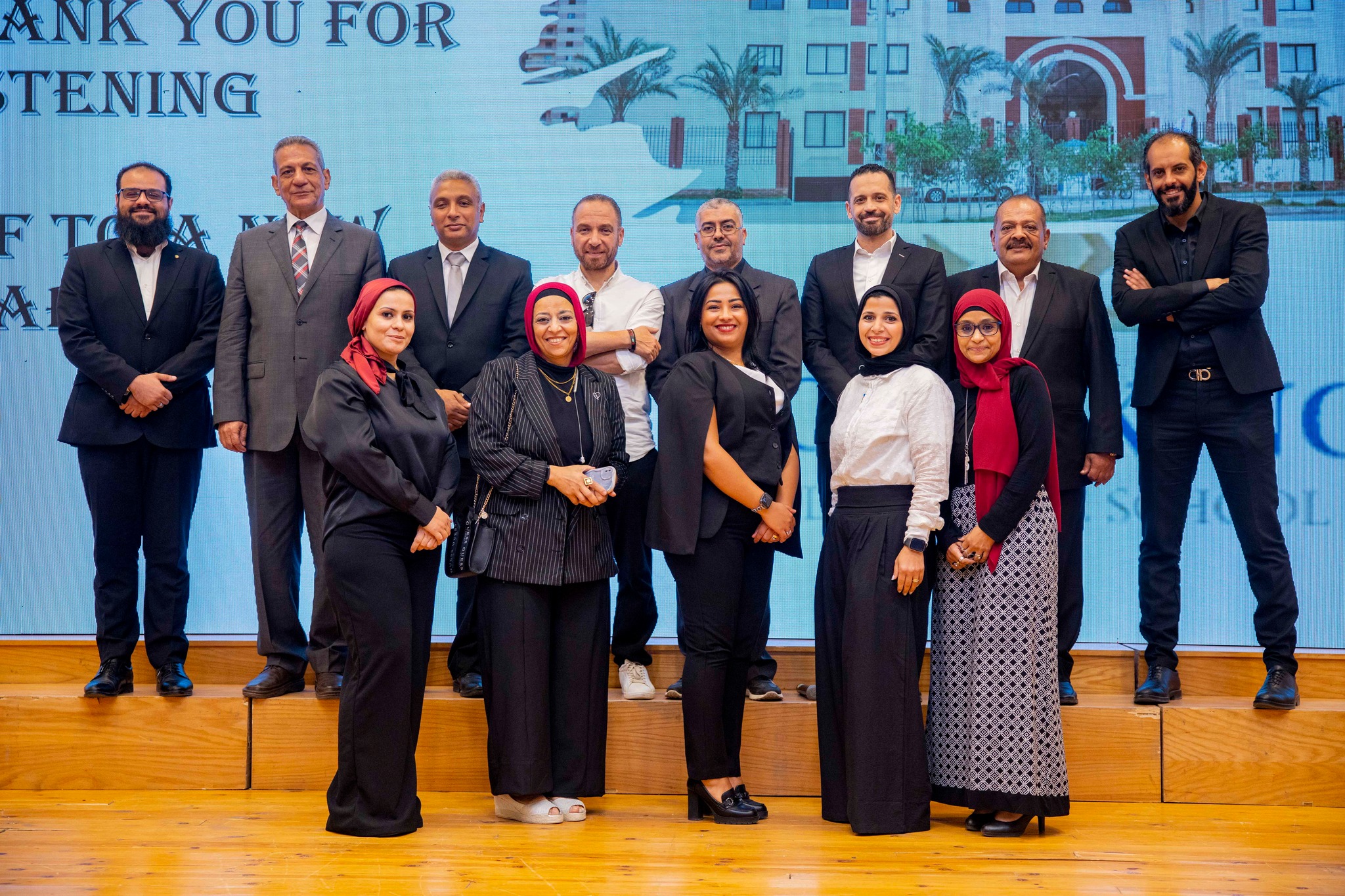 Royal Kings Schools leadership and staff group photo on stage